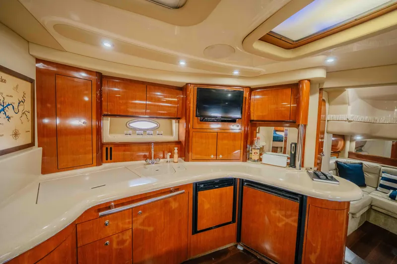 Slide: The Image of Luxurious 2003 Sea Ray 420 Sundancer yacht interior with elegant wood finishes and plush seating. - 10