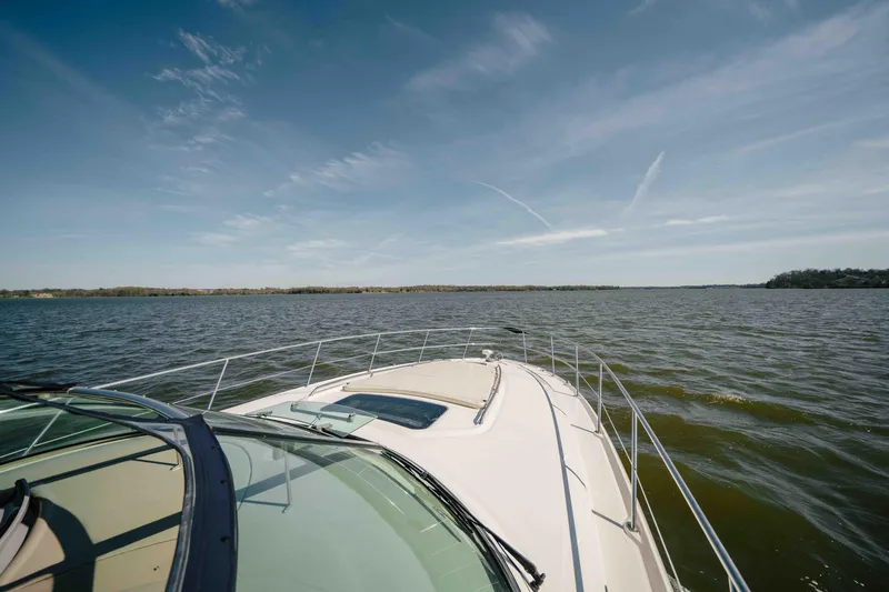 Slide: The Image of Luxurious interior of 2003 Sea Ray 420 Sundancer yacht with cozy seating and decorative pillows. - 12