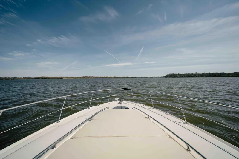 Slide: The Image of Luxurious interior of 2003 Sea Ray 420 Sundancer yacht with cozy seating and decorative pillows. - 13