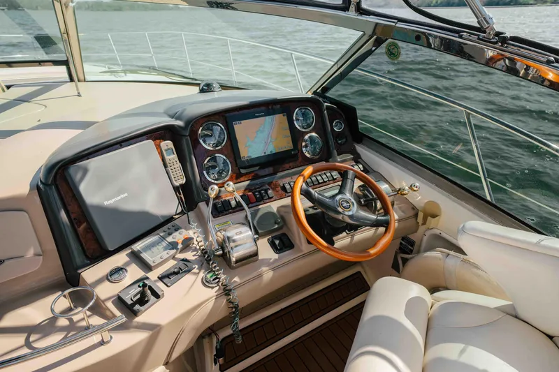 Slide: The Image of 2003 Sea Ray 420 Sundancer yacht interior with seating, table, and water view. - 19