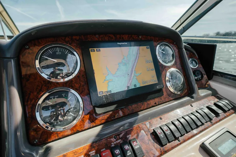 Slide: The Image of 2003 Sea Ray 420 Sundancer cruising on a calm lake under clear skies. - 23