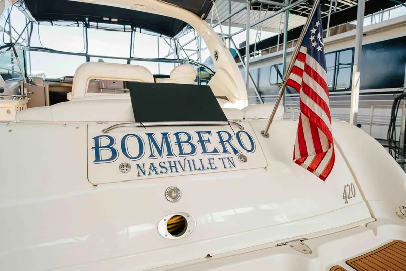 Slide: The Image of Cockpit of 2003 Sea Ray 420 Sundancer yacht with steering wheel and navigation equipment. - 25