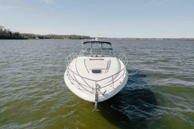 Slide: The Image of Helm of 2003 Sea Ray 420 Sundancer with gauges and controls, overlooking water. - 29