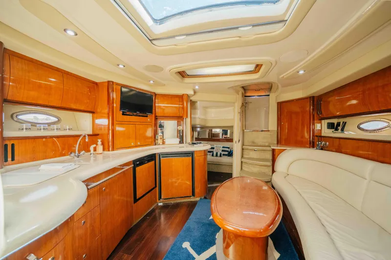 Slide: The Image of 2003 Sea Ray 420 Sundancer yacht cruising on a sunny day, displaying an American flag. - 3