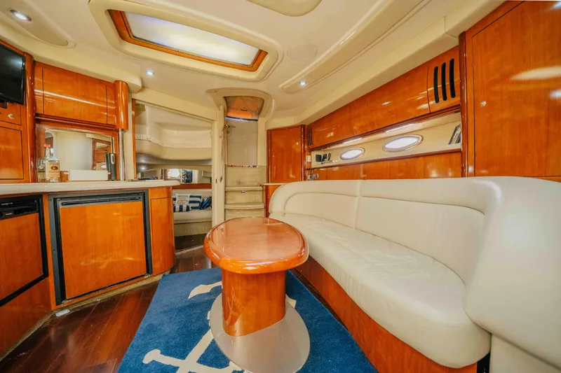 Slide: The Image of 2003 Sea Ray 420 Sundancer yacht on calm waters, front view. - 4