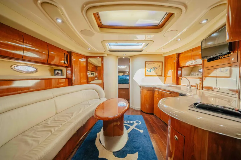 Slide: The Image of 2003 Sea Ray 420 Sundancer yacht cruising on a calm lake under clear skies. - 5