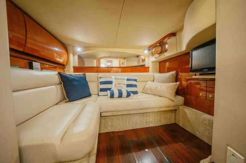 Slide: The Image of 2003 Sea Ray 420 Sundancer yacht on water, rear view, with "For Sale" sign. - 7