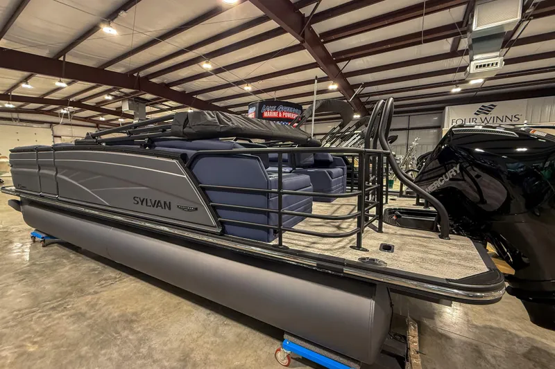 Slide: The Image of 2026 Sylvan G3 LZ DH pontoon boat in showroom, featuring sleek design and modern amenities. - 2
