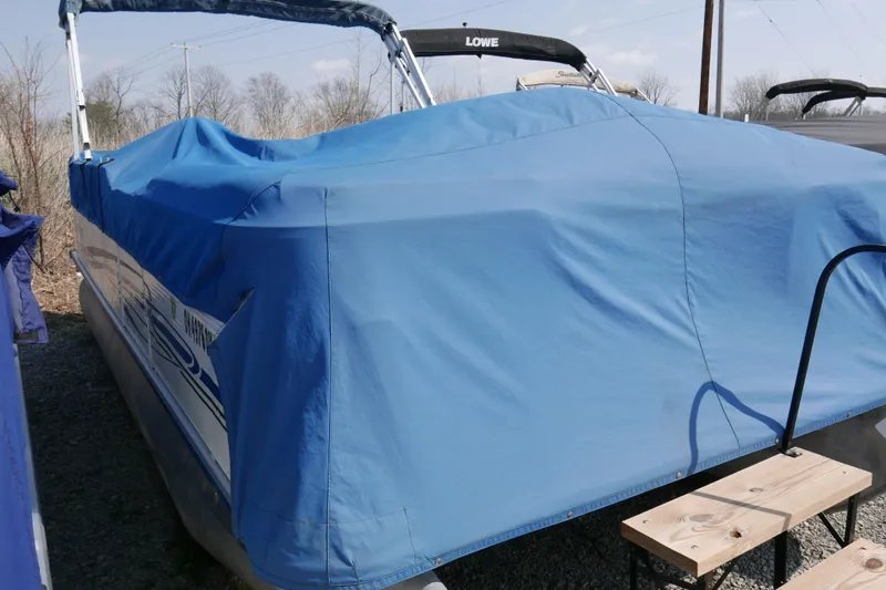 Slide: The Image of Covered 2005 Bentley Pontoons 200 CRUISE boat with blue tarp in outdoor storage. - 14