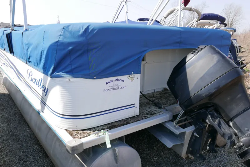 Slide: The Image of 2005 Bentley Pontoons 200 CRUISE with blue cover and outboard motor. - 15