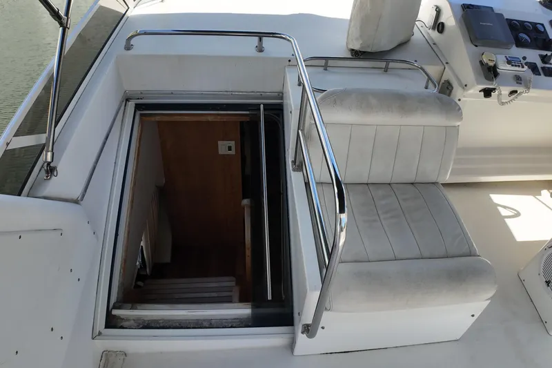 Slide: The Image of Stairway entrance on 2003 Navigator Rival yacht with white seating and control panel. - 10