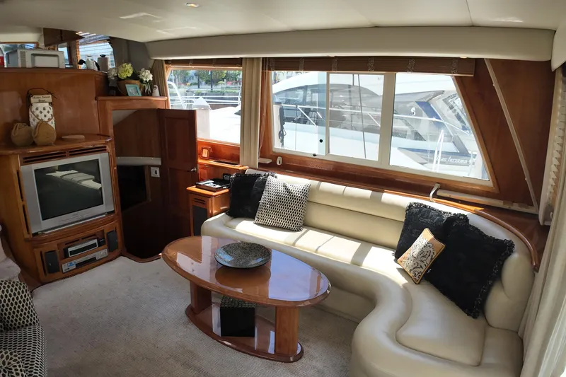 Slide: The Image of Luxurious 2003 Navigator Rival yacht interior with plush seating and entertainment center. - 16
