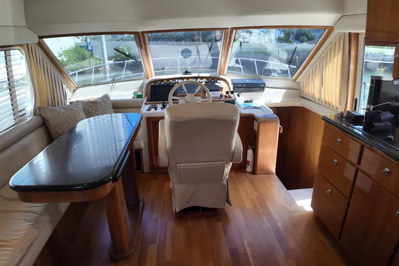 Slide: The Image of Luxurious 2003 Navigator Rival yacht interior with helm, seating, and wooden cabinetry. - 18
