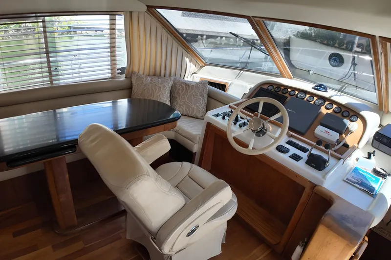 Slide: The Image of Interior of 2003 Navigator Rival yacht with helm, steering wheel, and seating area. - 19