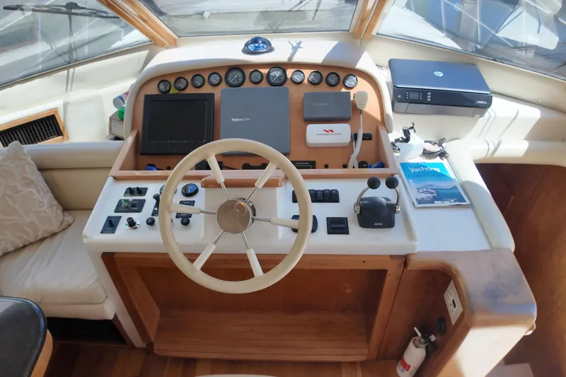 Slide: The Image of 2003 Navigator Rival yacht helm with steering wheel, controls, and navigation equipment. - 20