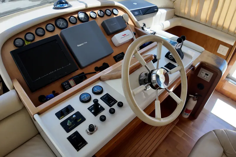 Slide: The Image of 2003 Navigator Rival yacht helm with steering wheel, gauges, and navigation equipment. - 22