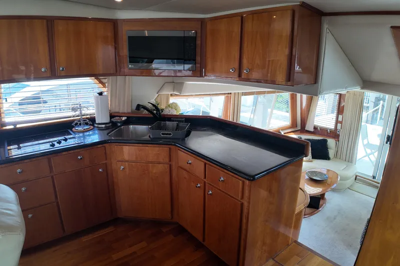 Slide: The Image of Luxurious 2003 Navigator Rival yacht kitchen with wood cabinetry and modern appliances. - 23
