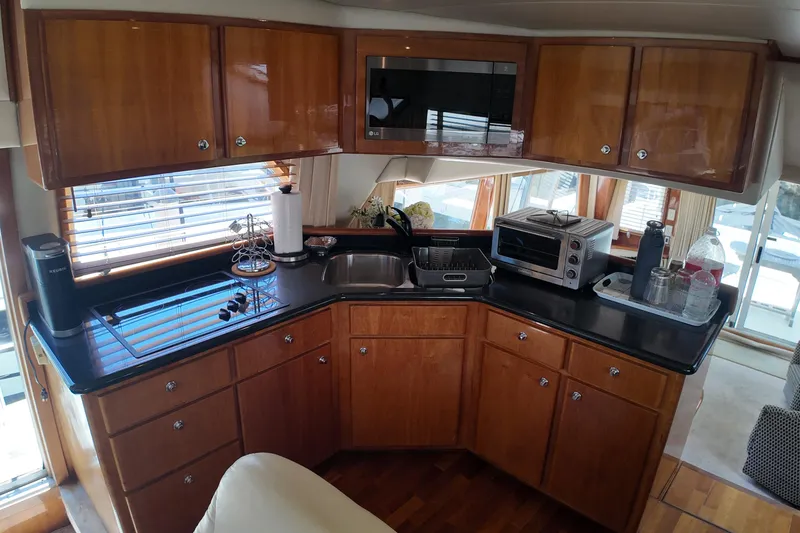 Slide: The Image of Luxurious 2003 Navigator Rival yacht kitchen with wooden cabinets and modern appliances. - 24