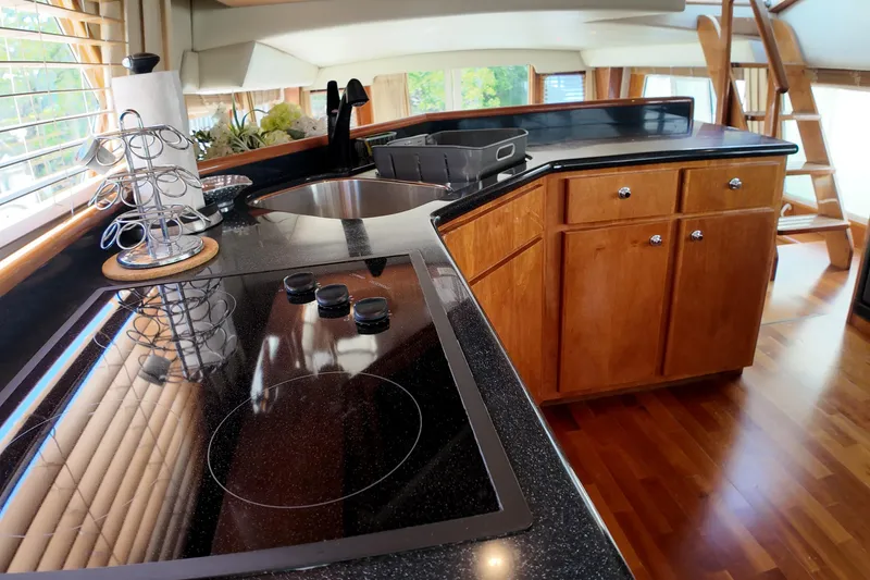 Slide: The Image of Modern kitchen interior on 2003 Navigator Rival yacht with wooden cabinets and sleek countertops. - 26