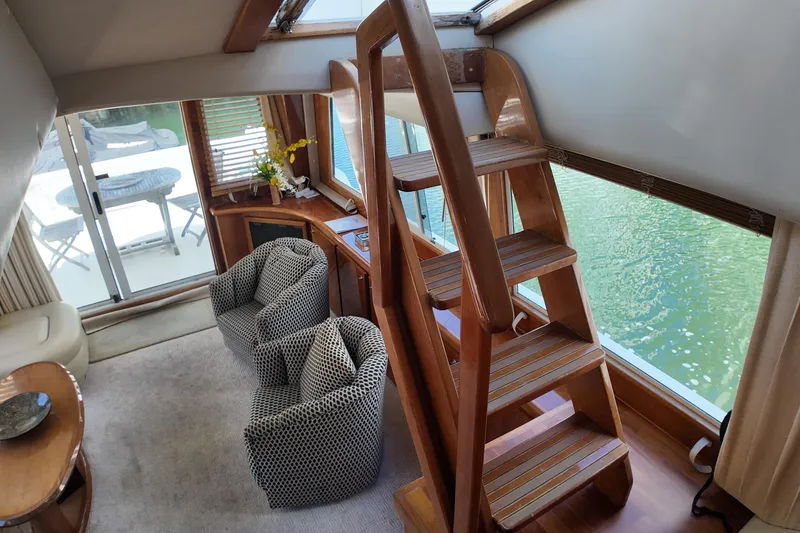 Slide: The Image of Interior of 2003 Navigator Rival yacht with wooden stairs and cozy seating area. - 29