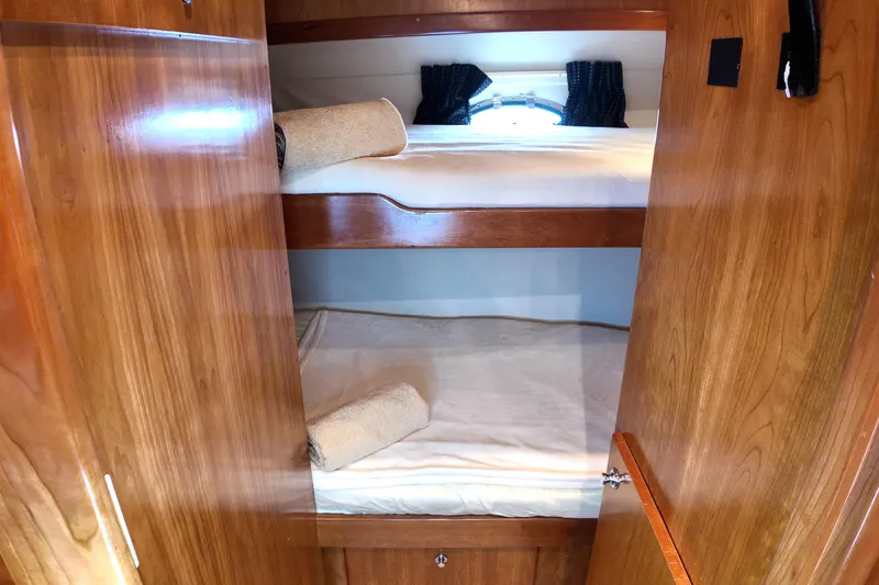 Slide: The Image of Wooden interior of 2003 Navigator Rival yacht with cozy bunk beds and porthole. - 35