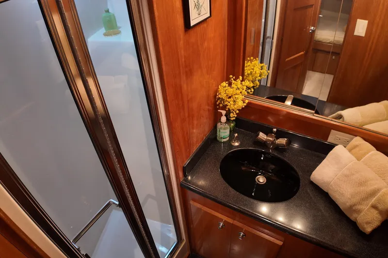 Slide: The Image of Luxurious 2003 Navigator Rival yacht bathroom with sleek black sink and elegant wood finishes. - 36
