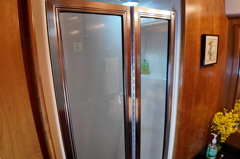 Slide: The Image of Shower area in 2003 Navigator Rival with wooden accents and decorative elements. - 37