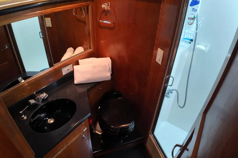Slide: The Image of Compact bathroom in 2003 Navigator Rival with sink, toilet, and shower. - 38