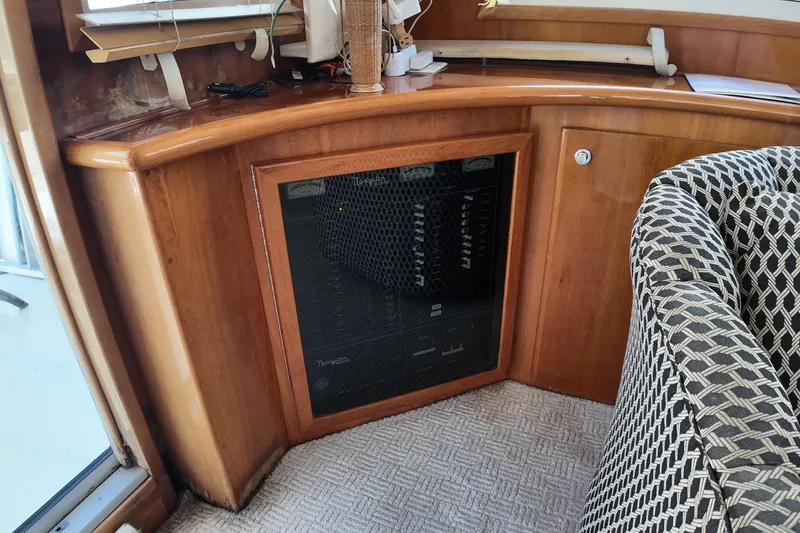 Slide: The Image of Wooden interior of a 2003 Navigator Rival yacht with patterned chair and built-in cabinet. - 39
