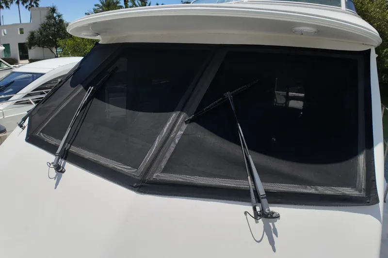 Slide: The Image of 2003 Navigator Rival yacht windshield with wipers, docked under clear skies. - 42