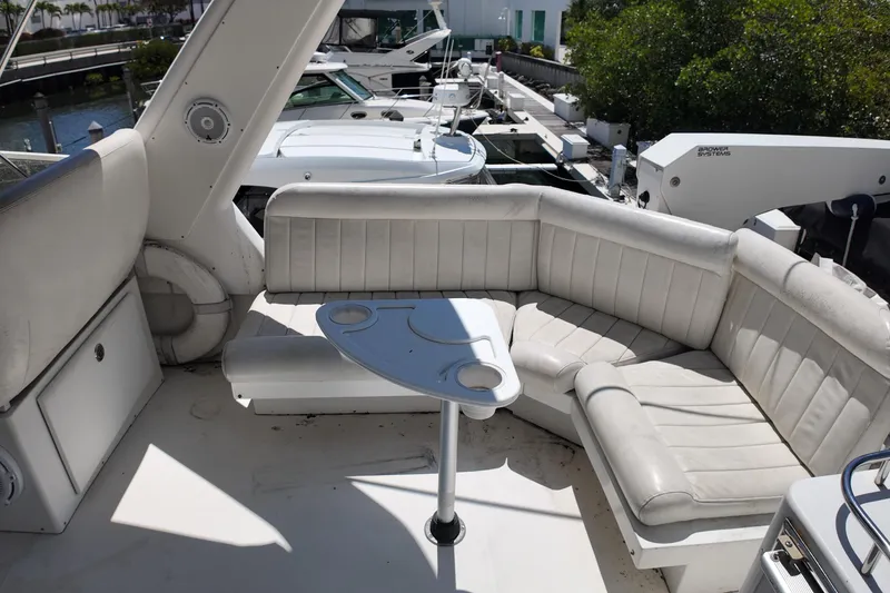 Slide: The Image of Luxurious 2003 Navigator Rival yacht with white leather seating and table, docked at marina. - 6