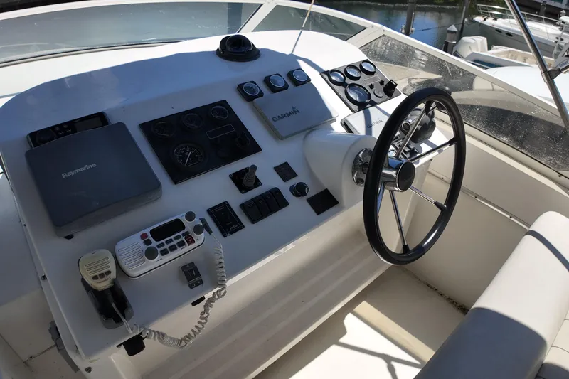 Slide: The Image of 2003 Navigator Rival boat helm with steering wheel and navigation controls. - 8