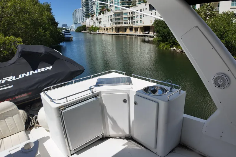 Slide: The Image of 2003 Navigator Rival yacht deck with sink, fridge, and scenic canal view. - 9