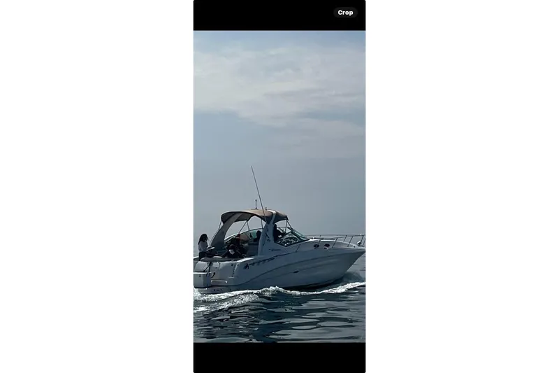 The Image of 2002 Sea Ray Sundancer 320 yacht docked at marina, featuring sleek design and spacious deck. - 0