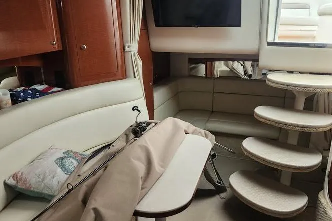 Slide: The Image of Interior of 2002 Sea Ray Sundancer 320 with seating, table, and stairs. - 12