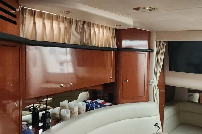 Slide: The Image of Interior of a 2002 Sea Ray Sundancer 320 yacht with wood cabinets and a cozy seating area. - 13