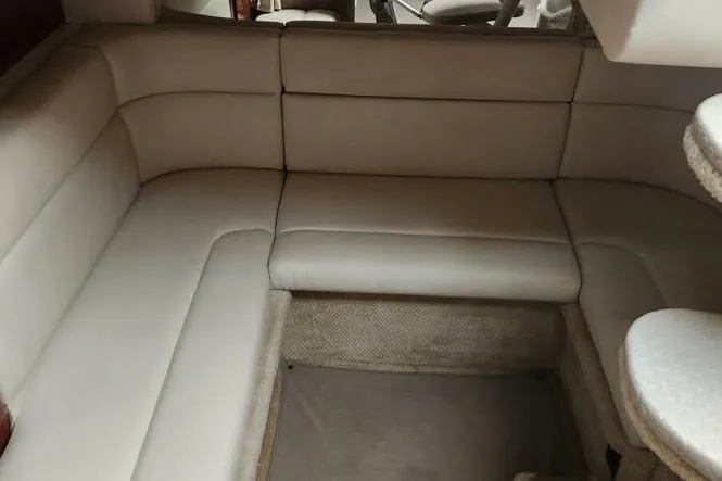 Slide: The Image of Interior seating of 2002 Sea Ray Sundancer 320 yacht, featuring beige upholstery. - 16