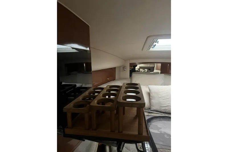 Slide: The Image of Interior of 2002 Sea Ray Sundancer 320 with wooden cup holder and cozy seating area. - 17