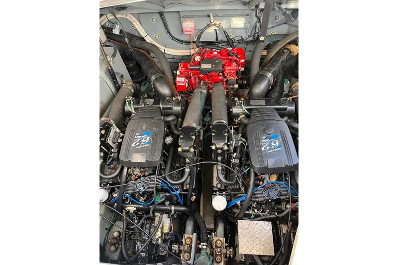 Slide: The Image of Engine compartment of a 2002 Sea Ray Sundancer 320, featuring dual Mercury engines. - 18