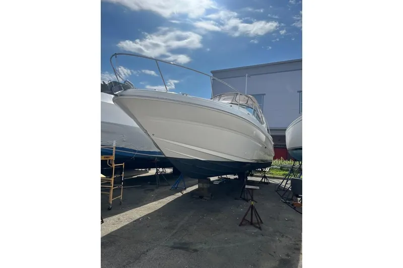 Slide: The Image of 2002 Sea Ray Sundancer 320 yacht with blue underwater lights at night. - 3