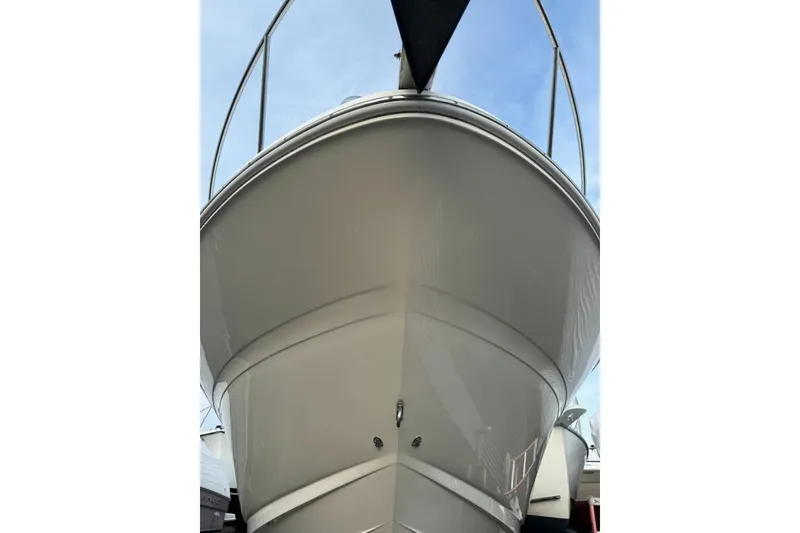 Slide: The Image of 2002 Sea Ray Sundancer 320 boat, front view, showcasing sleek hull design. - 4