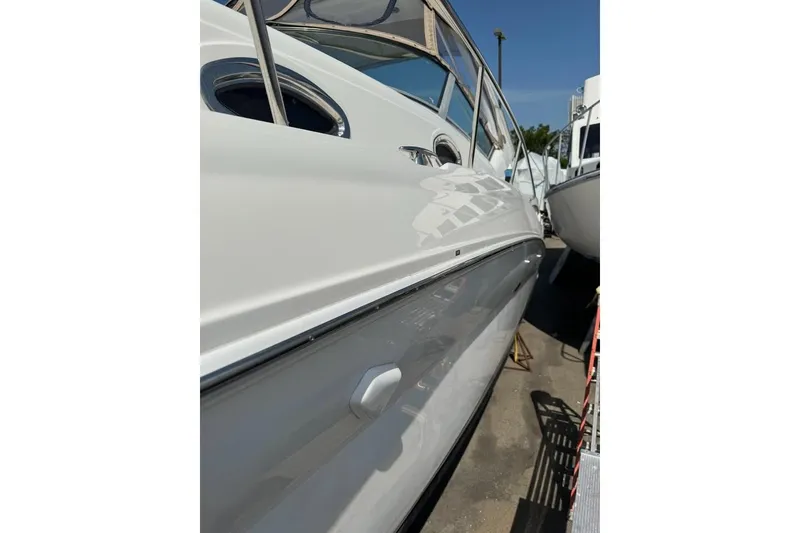 Slide: The Image of 2002 Sea Ray Sundancer 320 boat side view, showcasing sleek white hull design. - 6