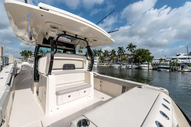 Slide: The Image of Manufacturer Provided Image: 2025 Scout 377 LXF boat docked in a marina, showcasing luxury seating and sleek design. - 10