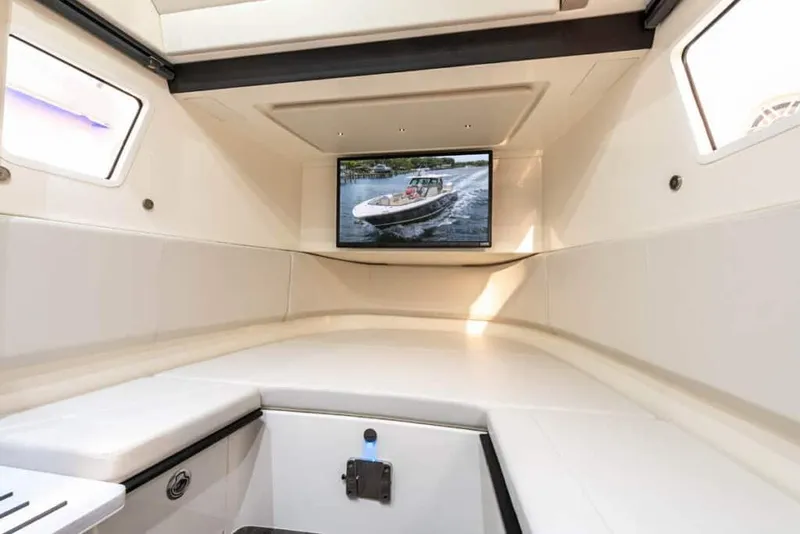 Slide: The Image of Manufacturer Provided Image: Luxurious interior of 2025 Scout 377 LXF boat with TV display. - 13