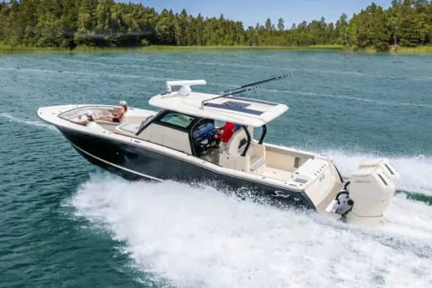 Slide: The Image of Manufacturer Provided Image: 2025 Scout 377 LXF boat cruising on a lake with lush forest background. - 3