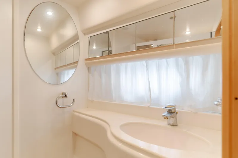 Slide: The Image of Bathroom interior of 1997 Viking Sport Cruisers 66 Motor Yacht, featuring mirror and sink. - 12