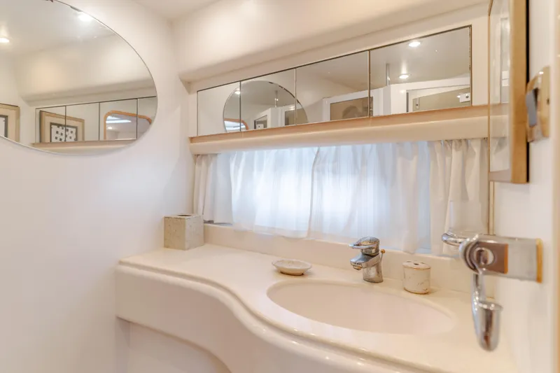 Slide: The Image of Luxurious bathroom interior of 1997 Viking Sport Cruisers 66 Motor Yacht with elegant fixtures. - 14