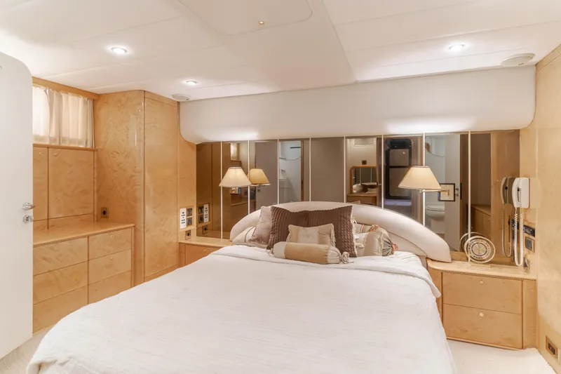 Slide: The Image of Luxurious bedroom interior of 1997 Viking Sport Cruisers 66 Motor Yacht with elegant wood finishes. - 16