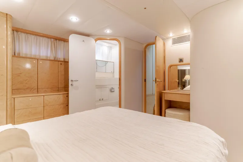 Slide: The Image of Luxurious interior of 1997 Viking Sport Cruisers 66 Motor Yacht bedroom with elegant wood finishes. - 17