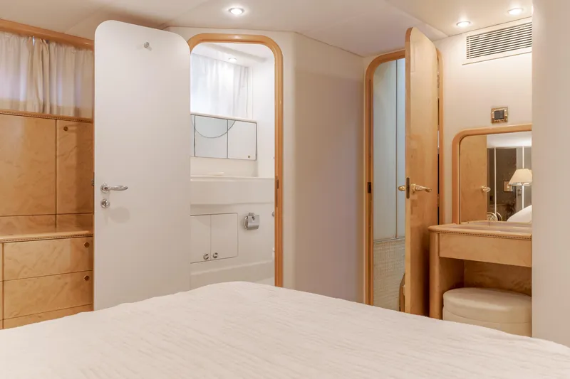 Slide: The Image of Interior of 1997 Viking Sport Cruisers 66 Motor Yacht, featuring bedroom and bathroom. - 18